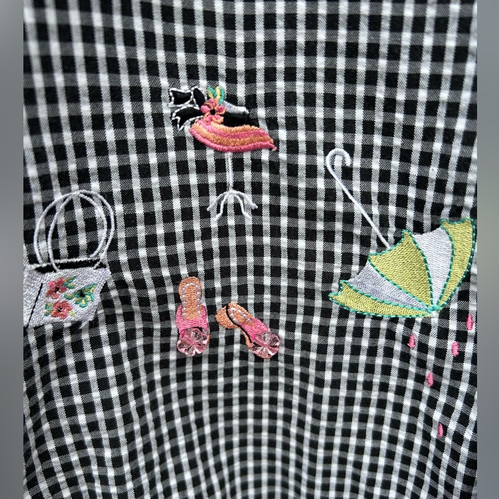 Short sleeve, button up, black-and-white checkered pattern and embellishments